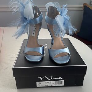 Brand New Nina sky blue heels with feather ankle accents.